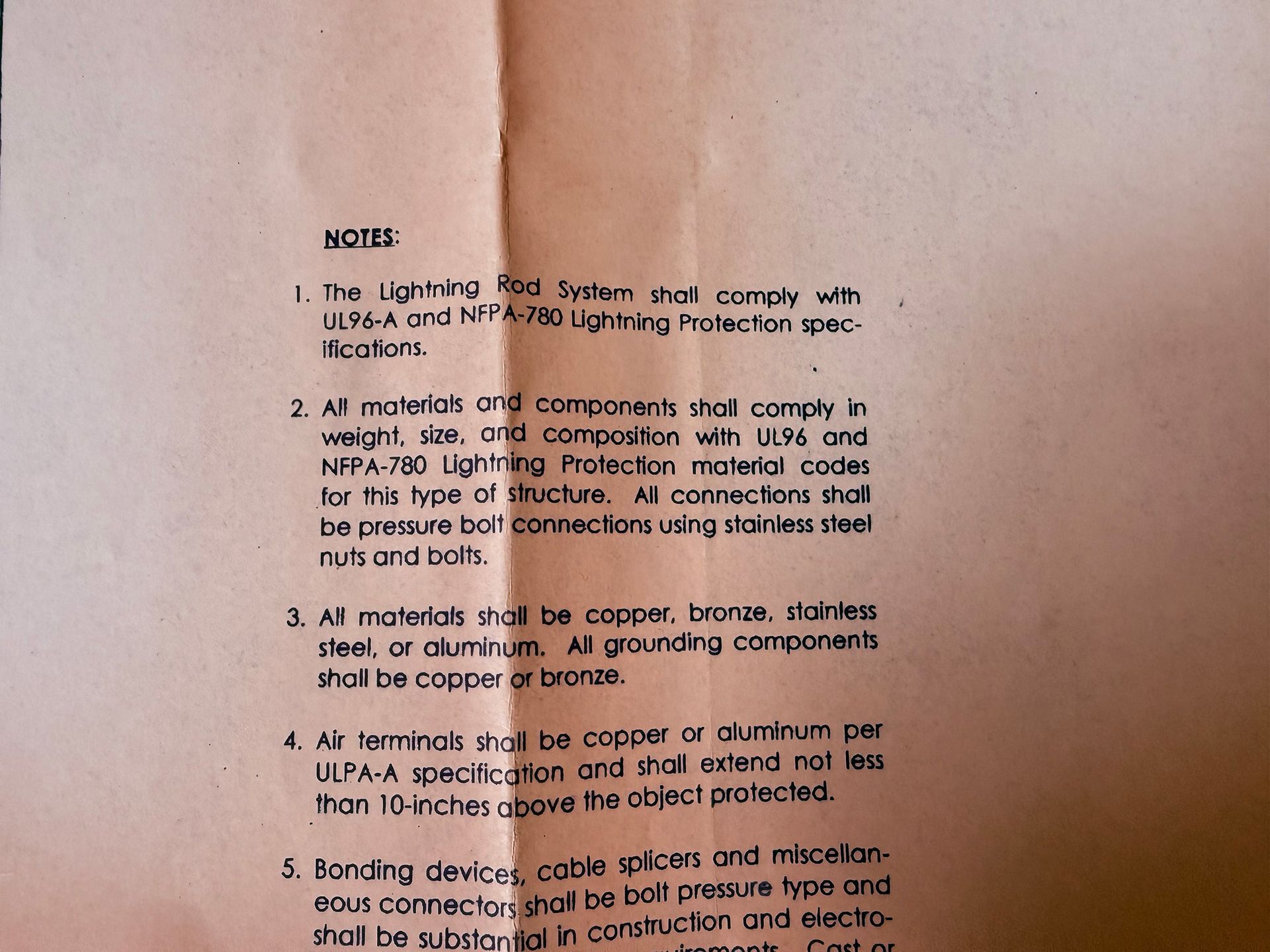 A list of five technical notes regarding lightning protection system specifications printed on tan paper.