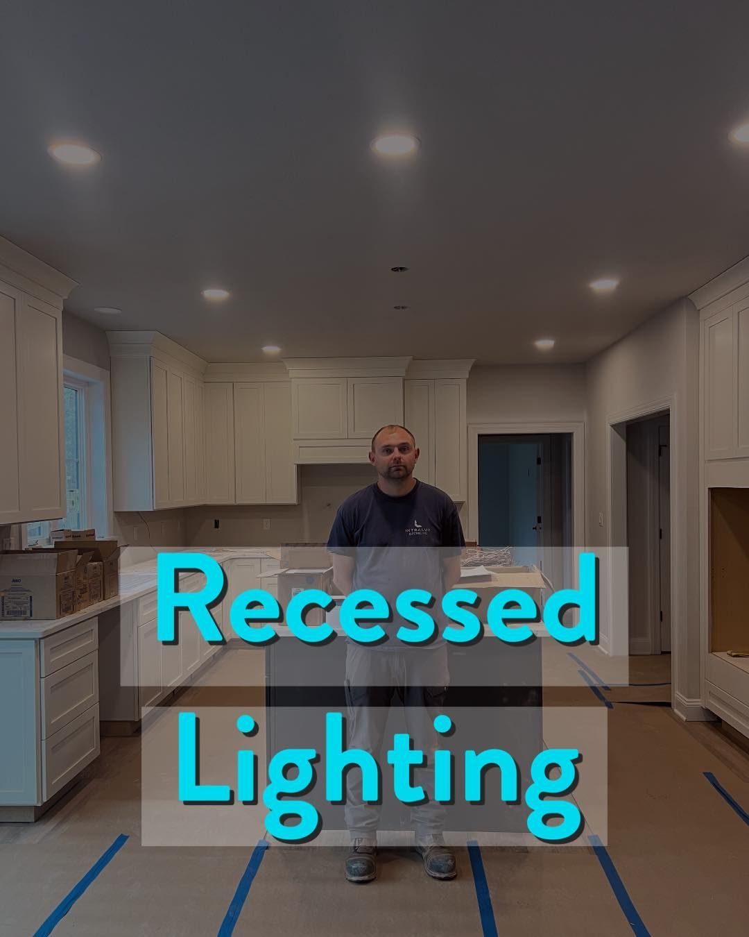 Man in a kitchen with recessed lighting installation.