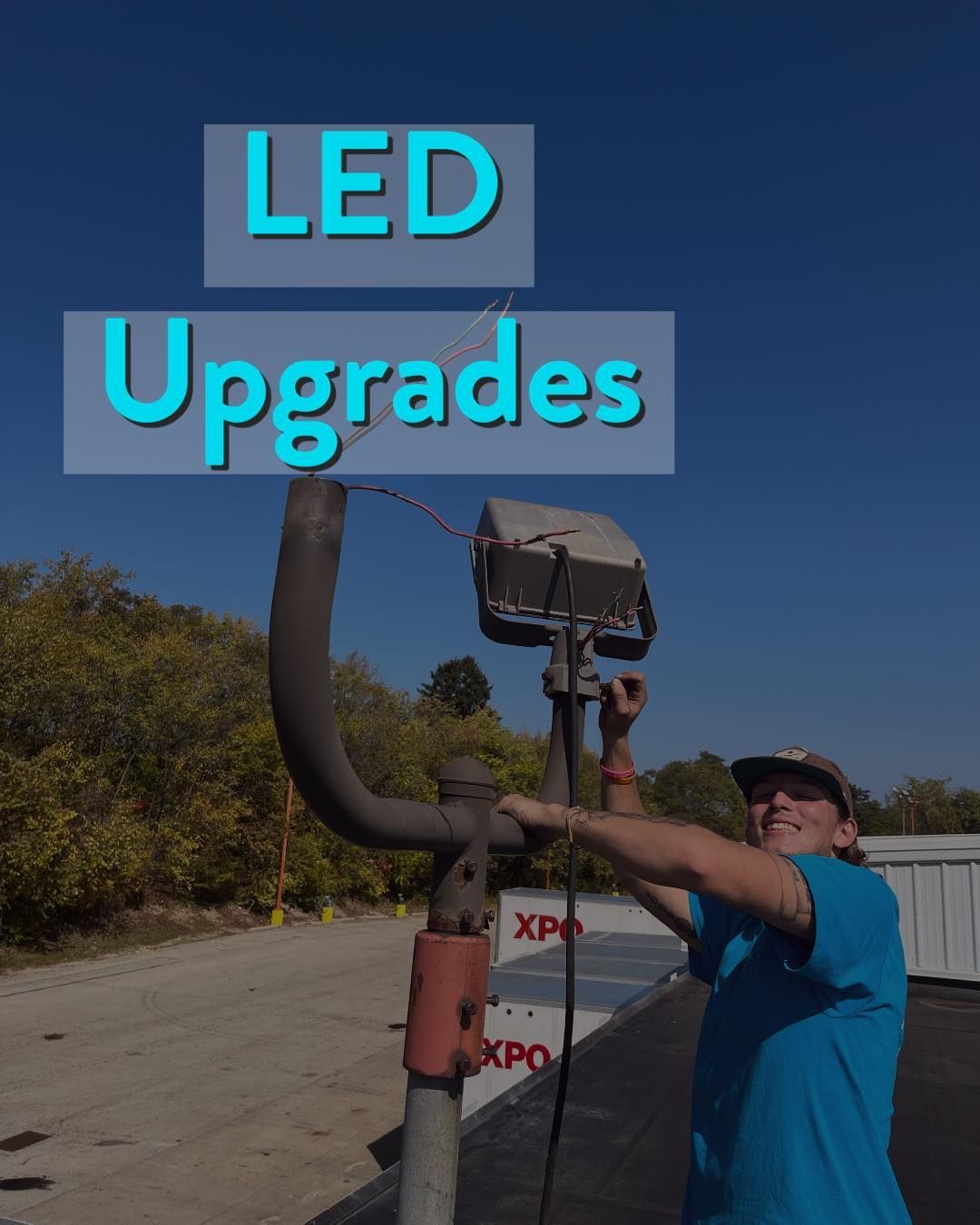Person working on an outdoor light fixture for LED upgrades. 