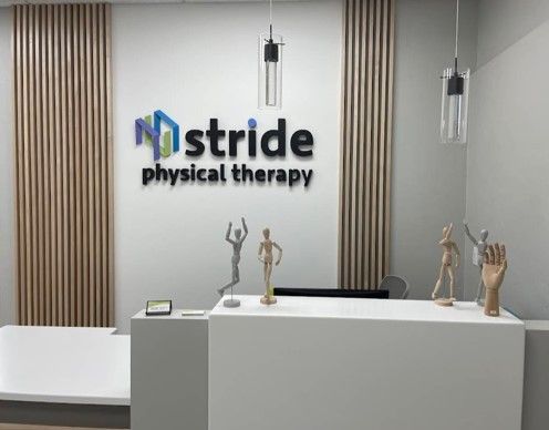 A rendering of a physical therapy office with a sign on the wall.