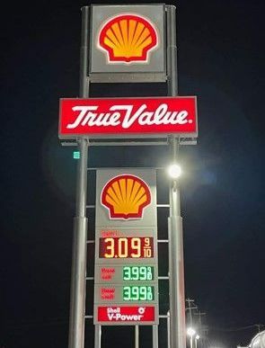 A shell gas station with a sign that says true value.