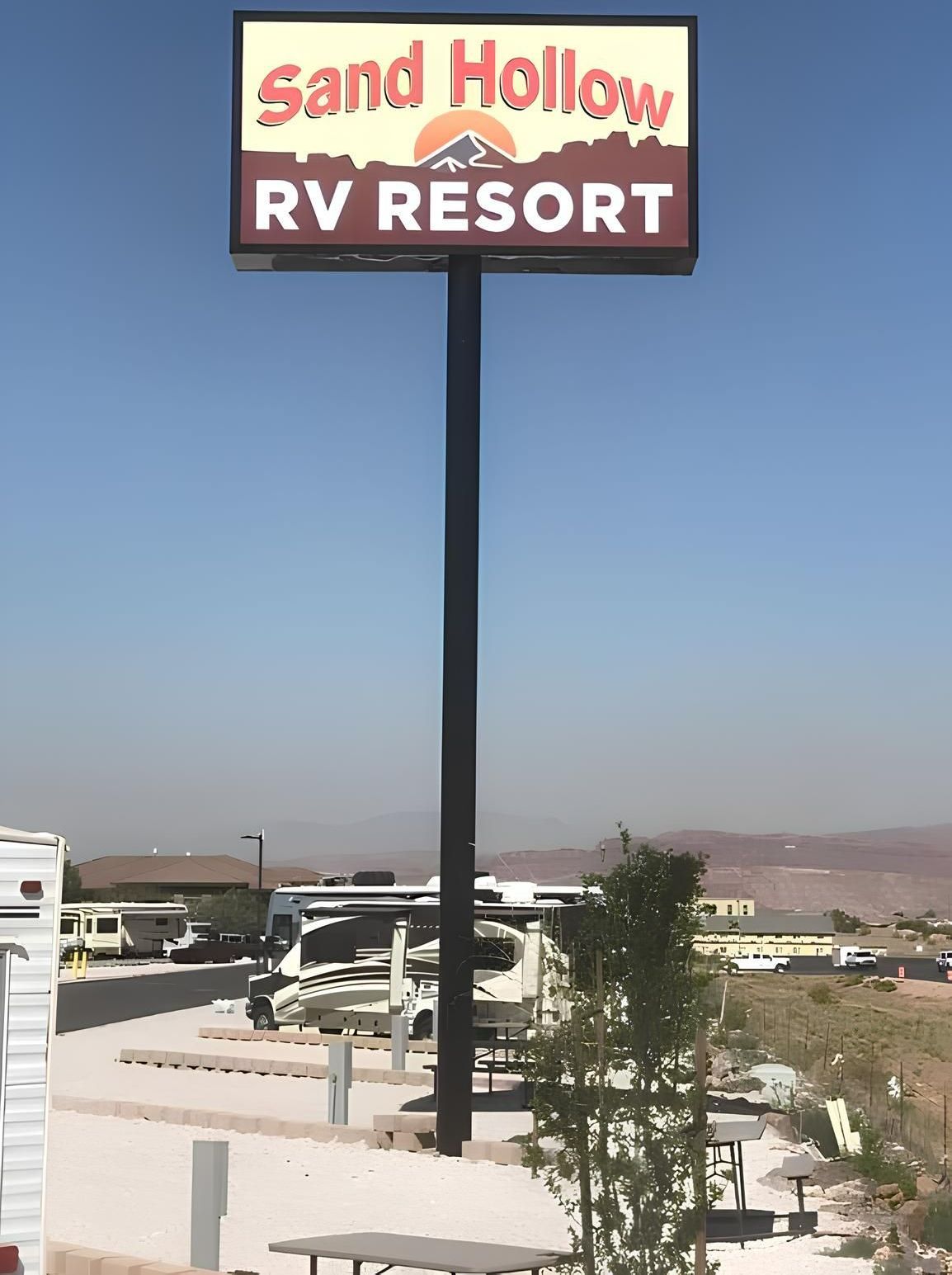 A large sign for the sand hollow rv resort.