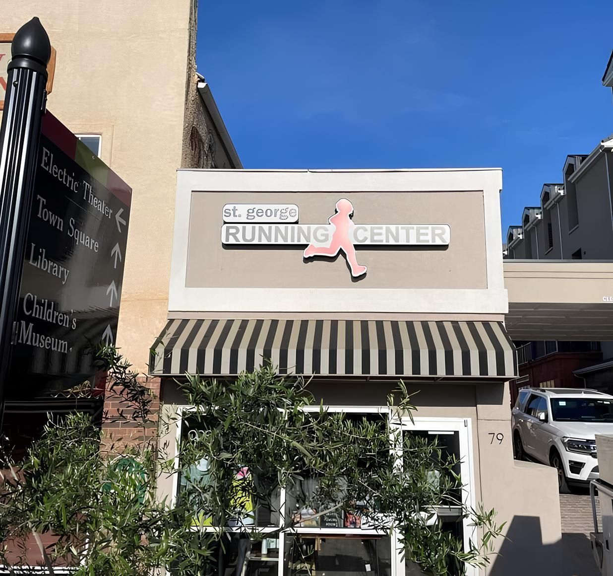 The front of a running center with a striped awning