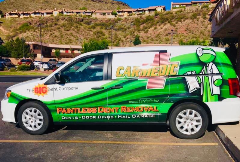 A car medic van is parked in a parking lot.