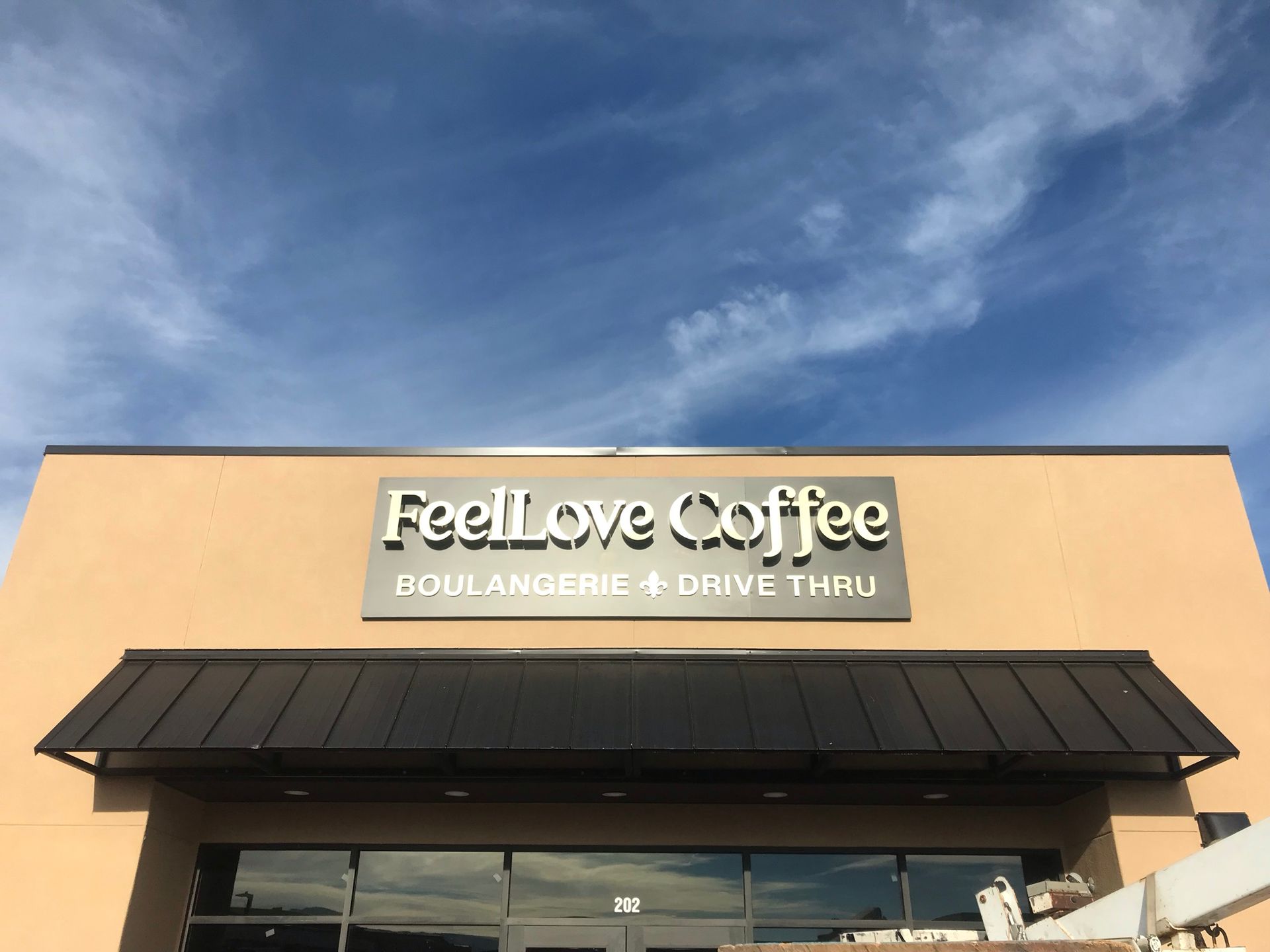 a building with a sign that says feel love coffee on it