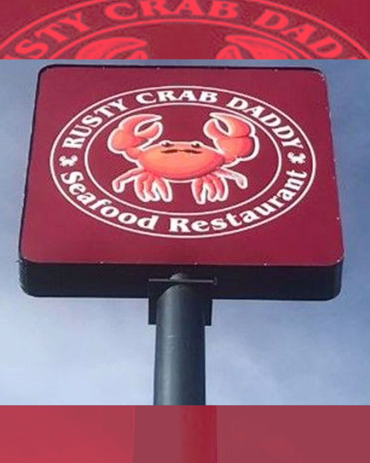 A rusty crab daddy seafood restaurant sign.