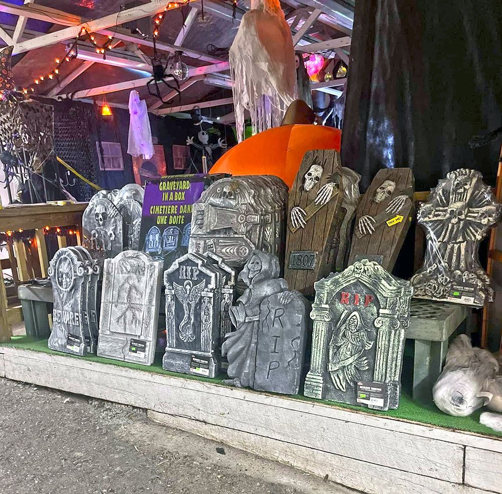 A display of gravestones and coffins with one that says rip on it