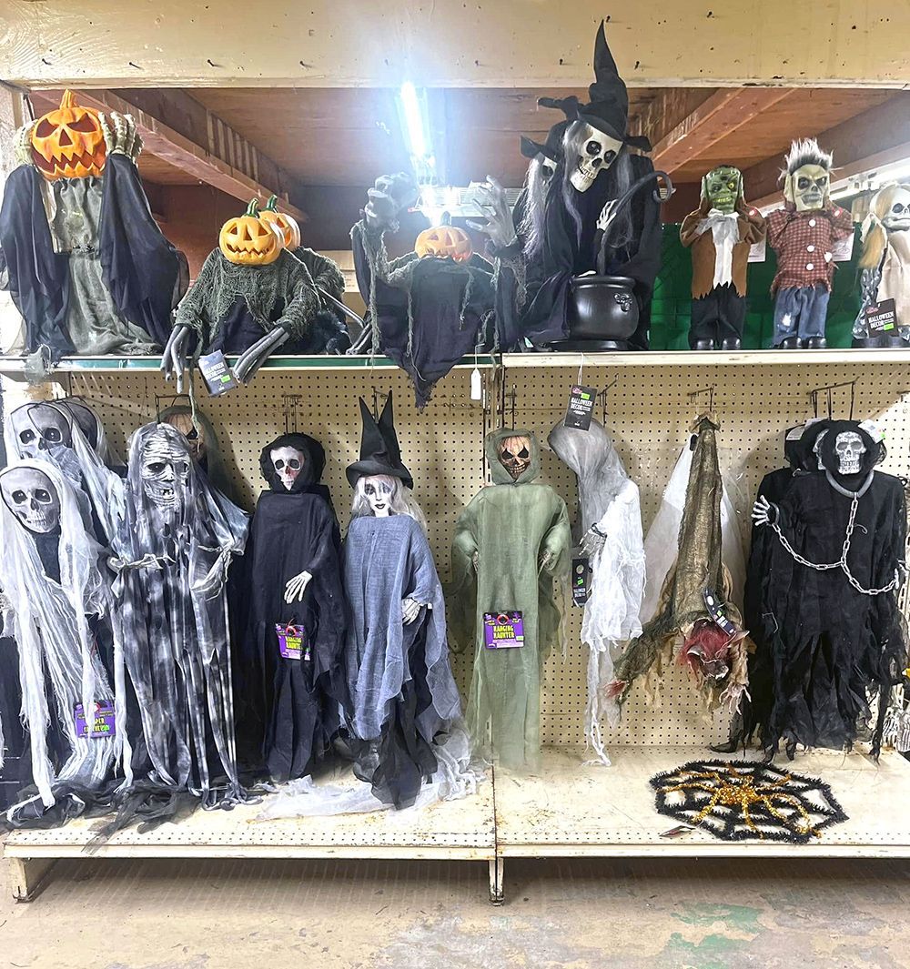 A shelf filled with lots of halloween decorations.