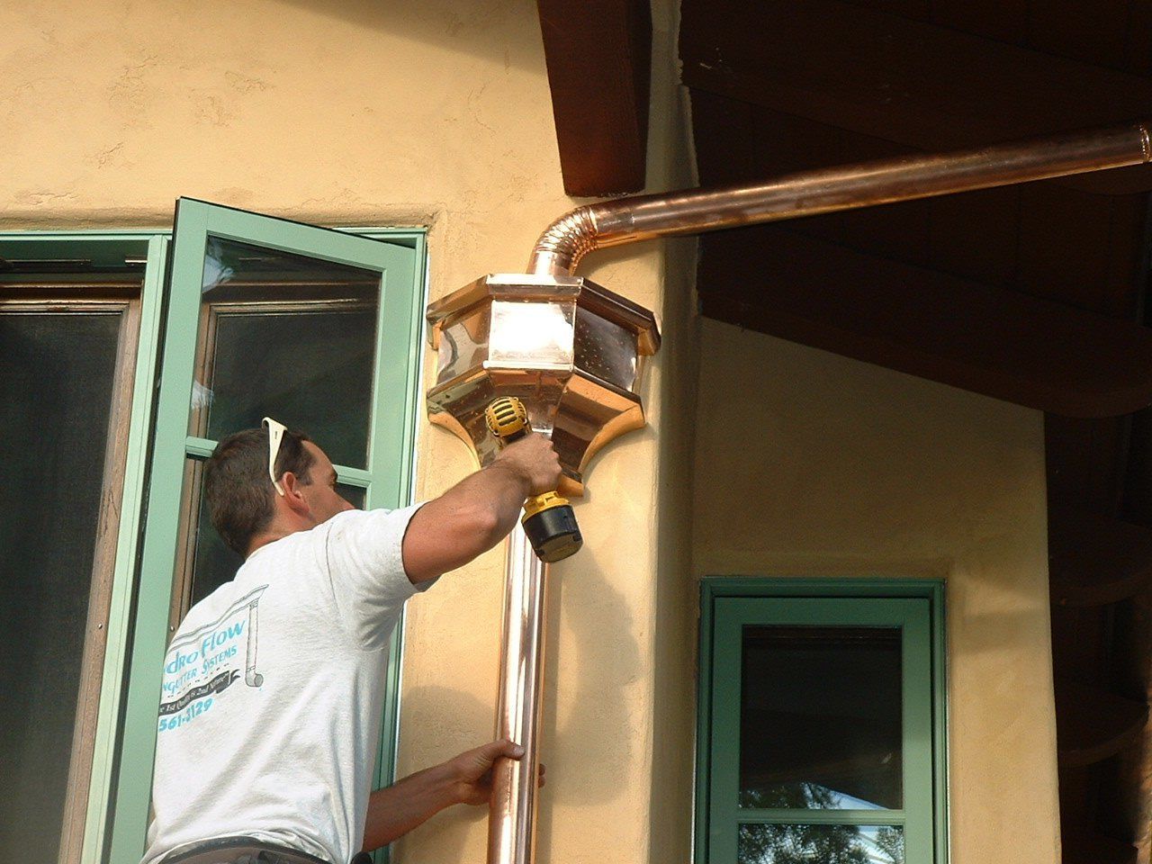 Worker installing new gutter