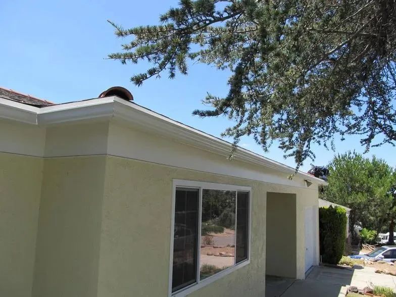 A house with a roof that has a gutter on it