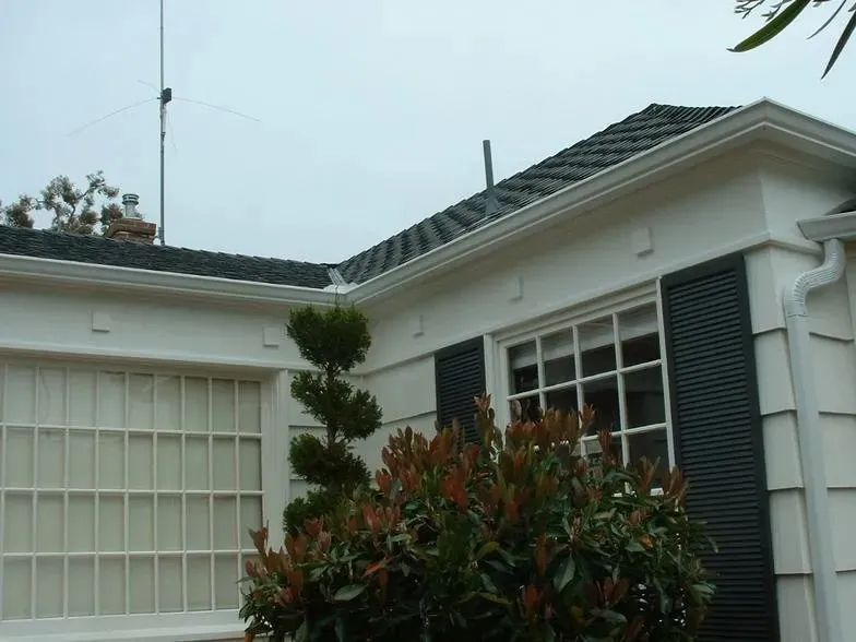 A white house with a black roof and black shutters