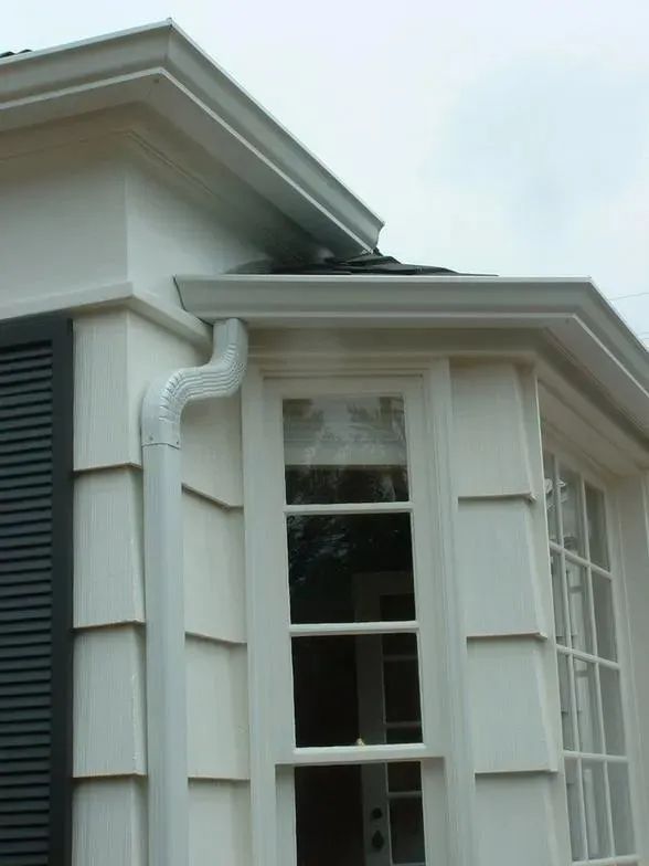 A white house with black shutters and a window