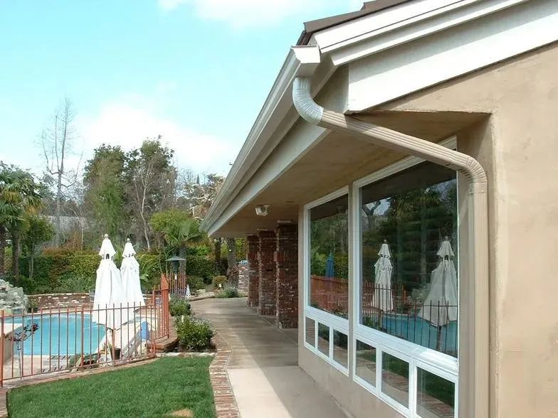 A house with a pool and umbrellas in the backyard