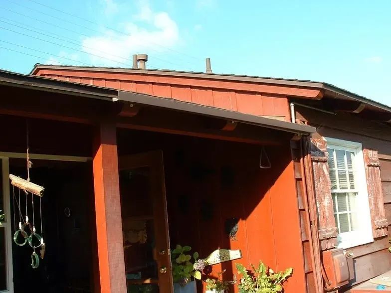 A red house with a porch and a window