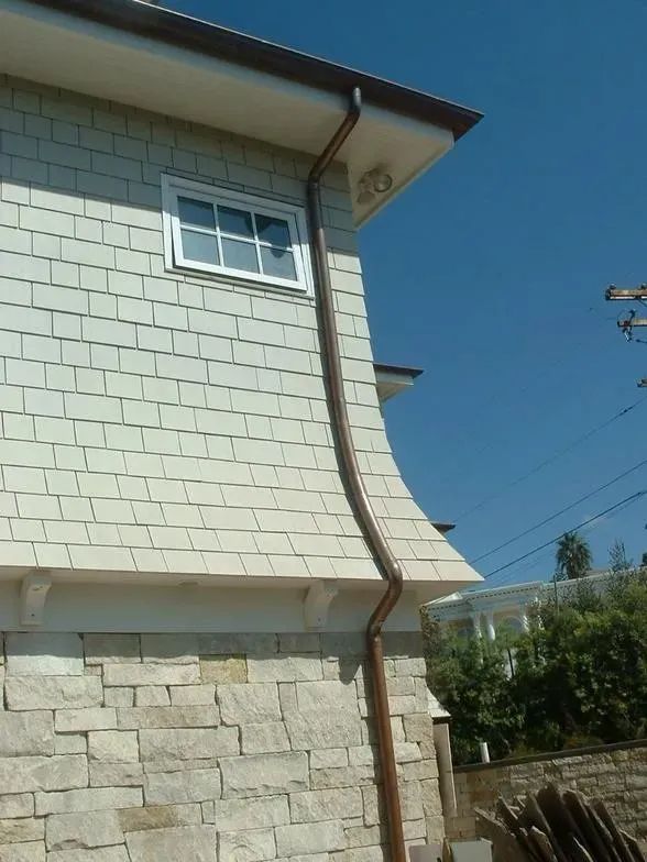 A house with a gutter on the side of it