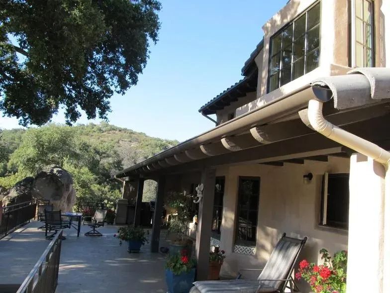 A house with a roof that has a gutter on it
