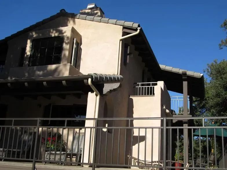 A house with a balcony and a metal railing