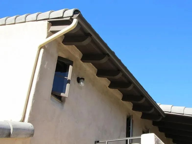 A house with a gutter on the side of it
