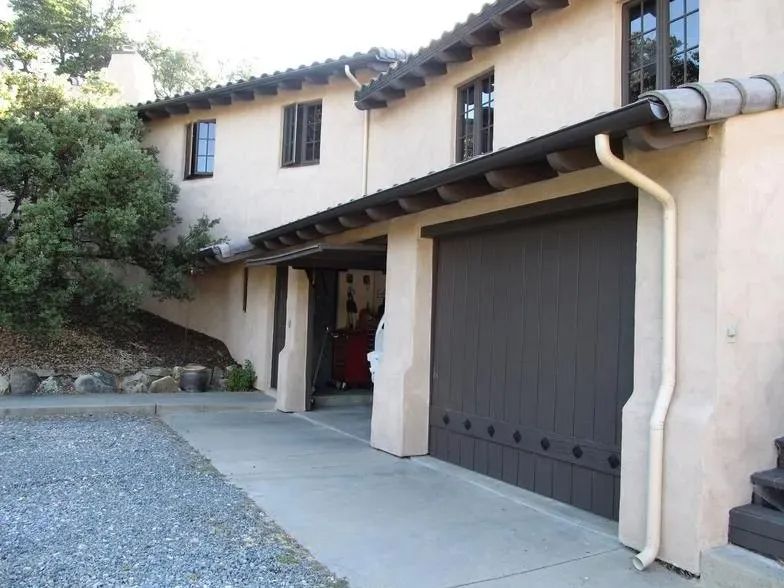 A house with a brown garage door and a white gutter