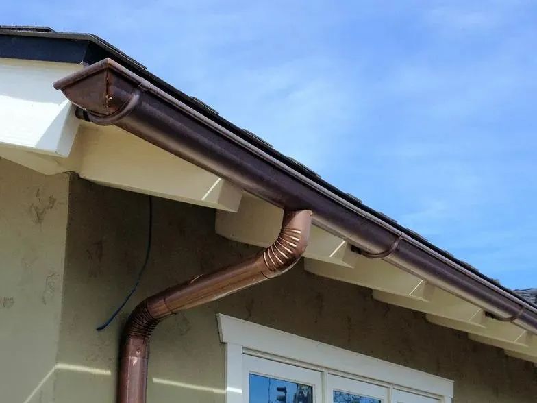 A copper gutter on the side of a house