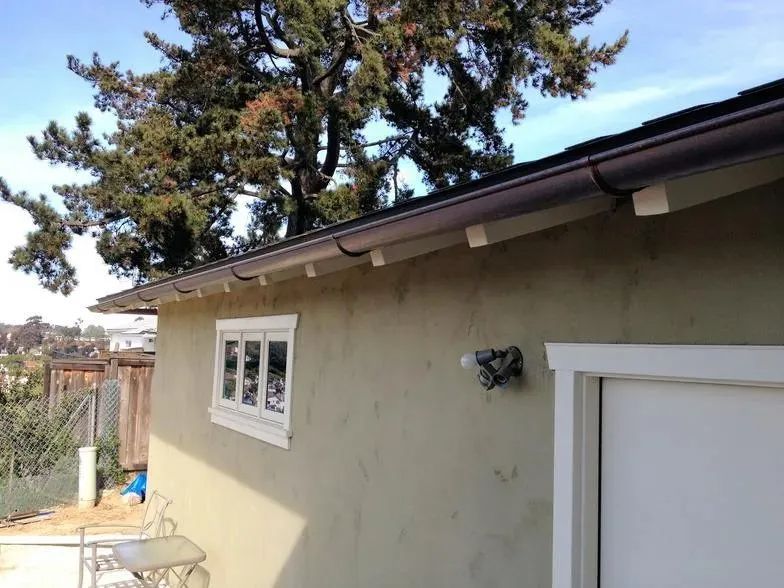 A house with a gutter on the side of it