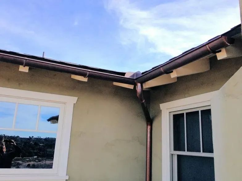 A house with a window and a gutter on the side