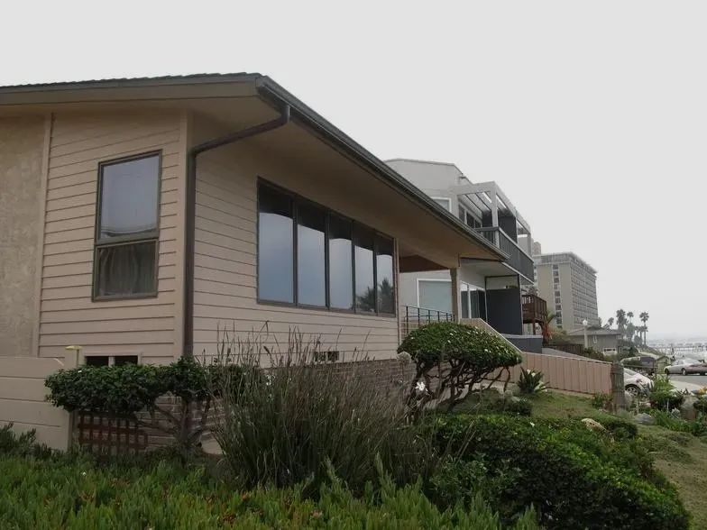 A house with a lot of windows and a gutter
