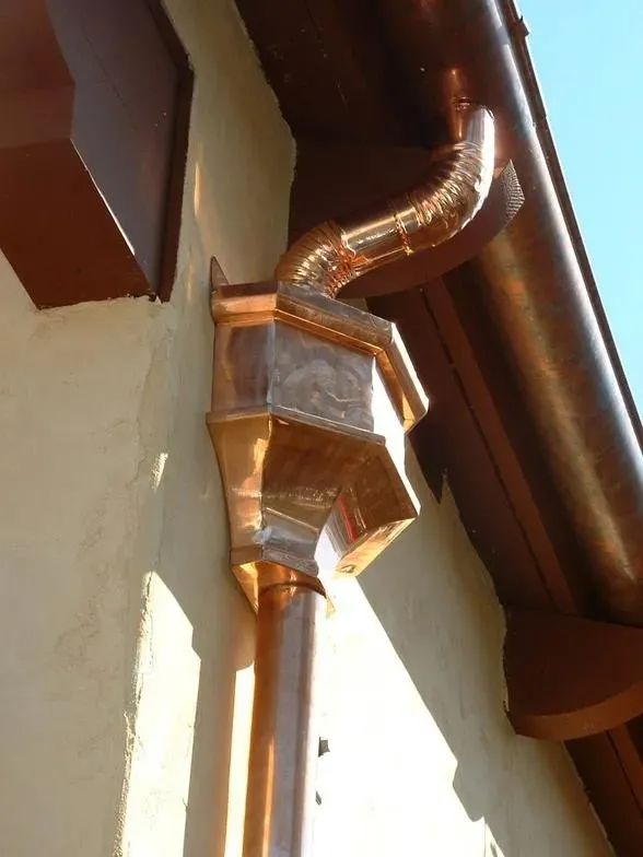 A copper gutter on the side of a building