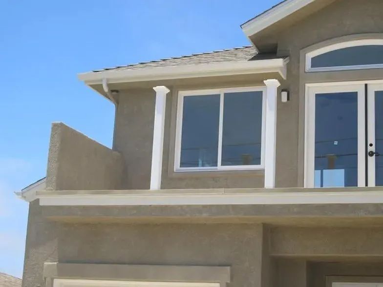 A house with a balcony and sliding glass doors