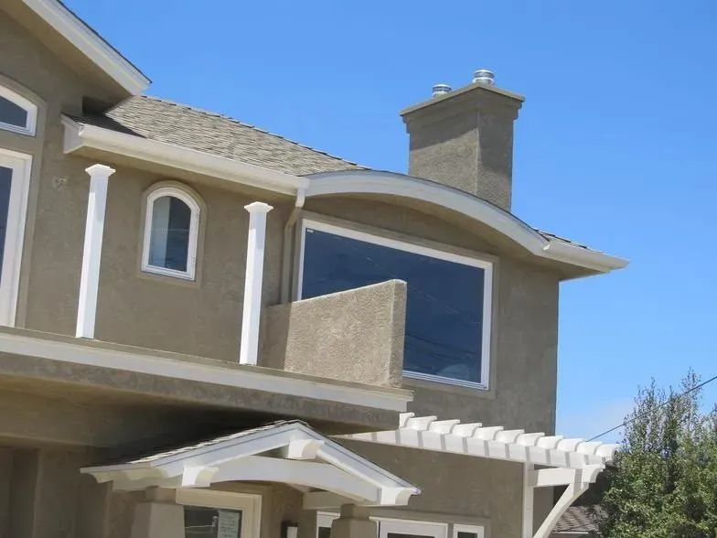 A large house with a blue sky in the background