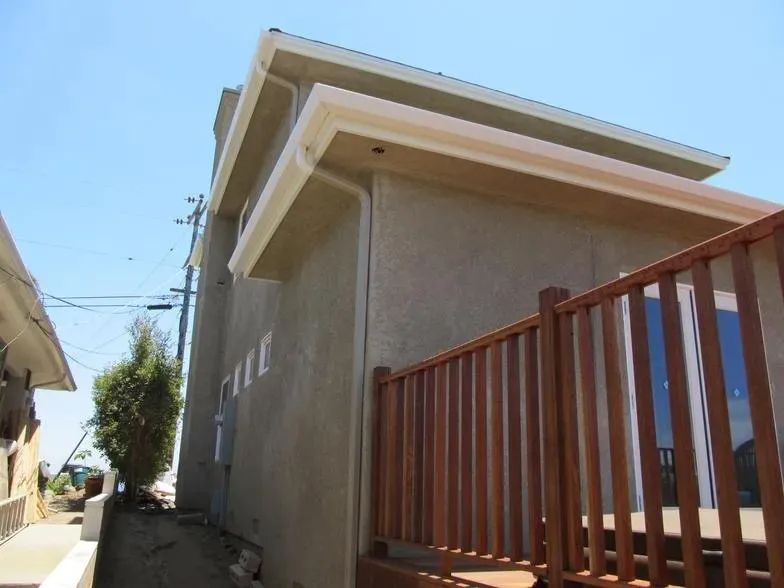 The side of a house with a wooden railing