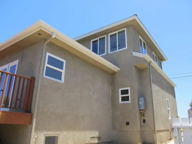 A house with a lot of windows and a balcony