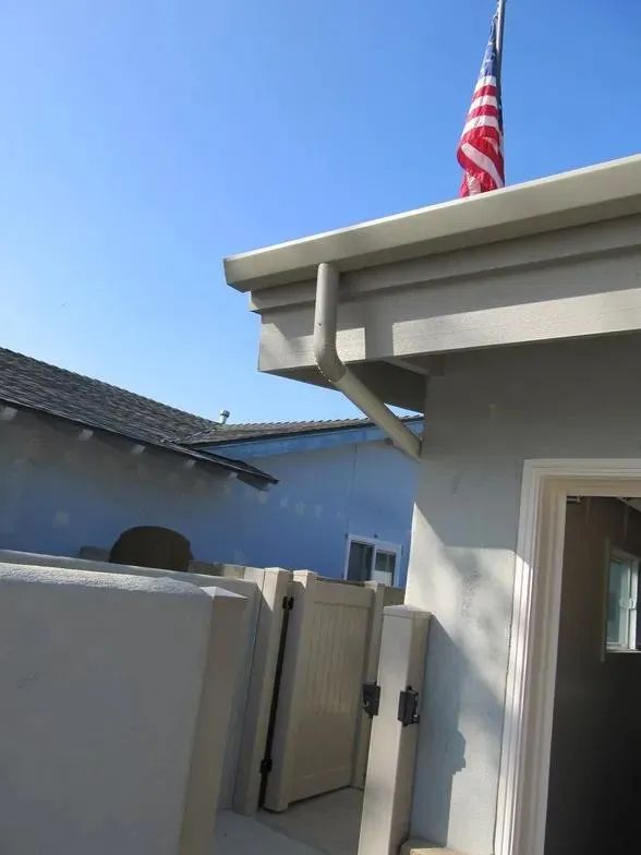 An american flag is flying from the roof of a house
