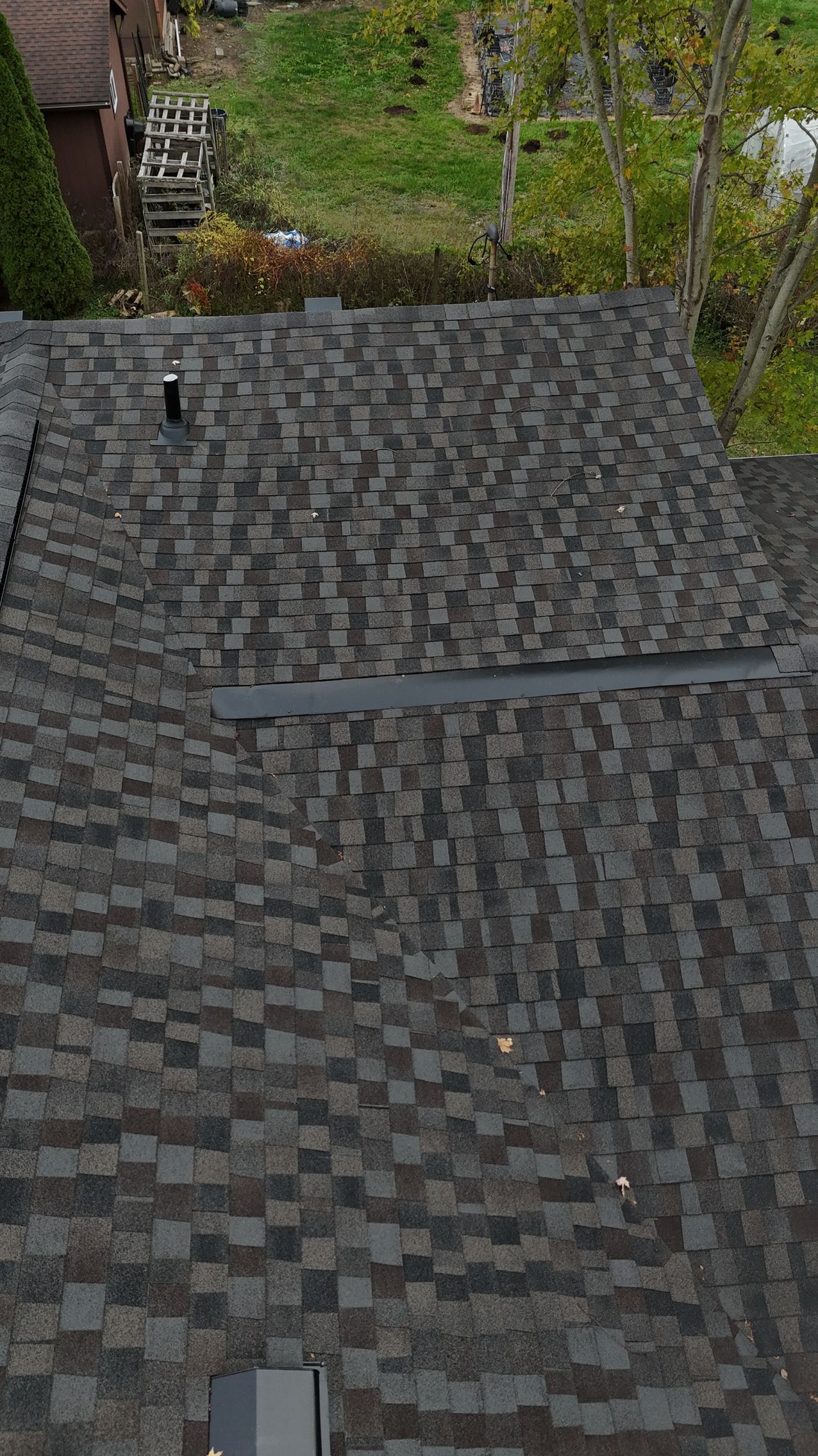 Overhead view of a dark gray asphalt shingle roof.