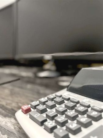 A close up of a calculator on a table