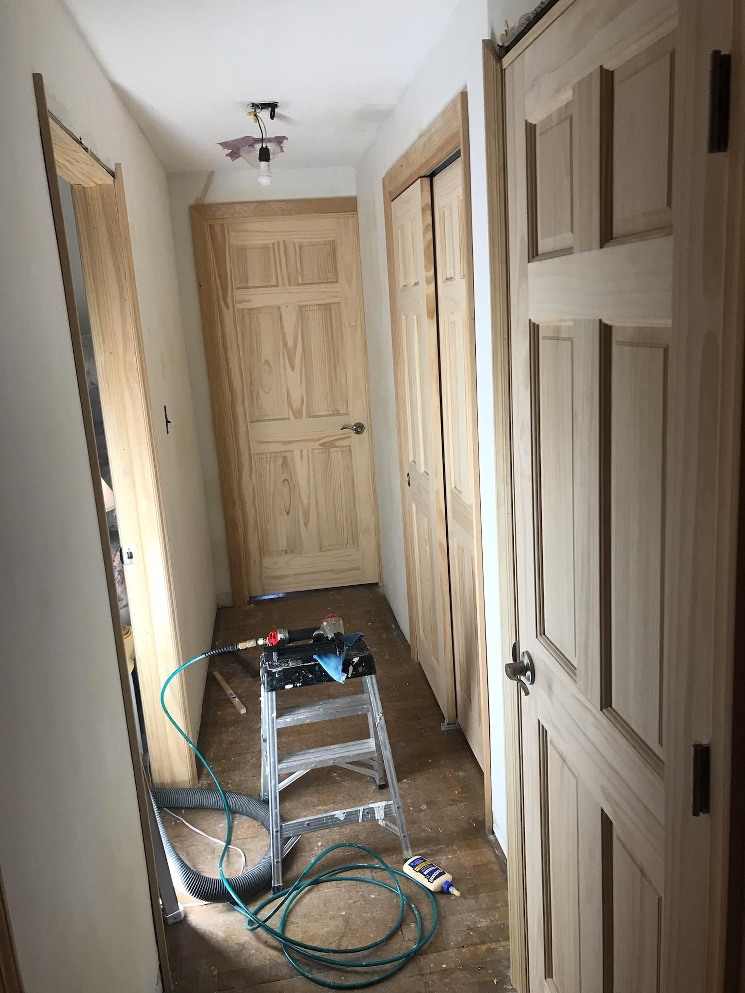 A large chandelier is hanging from the ceiling of a house.