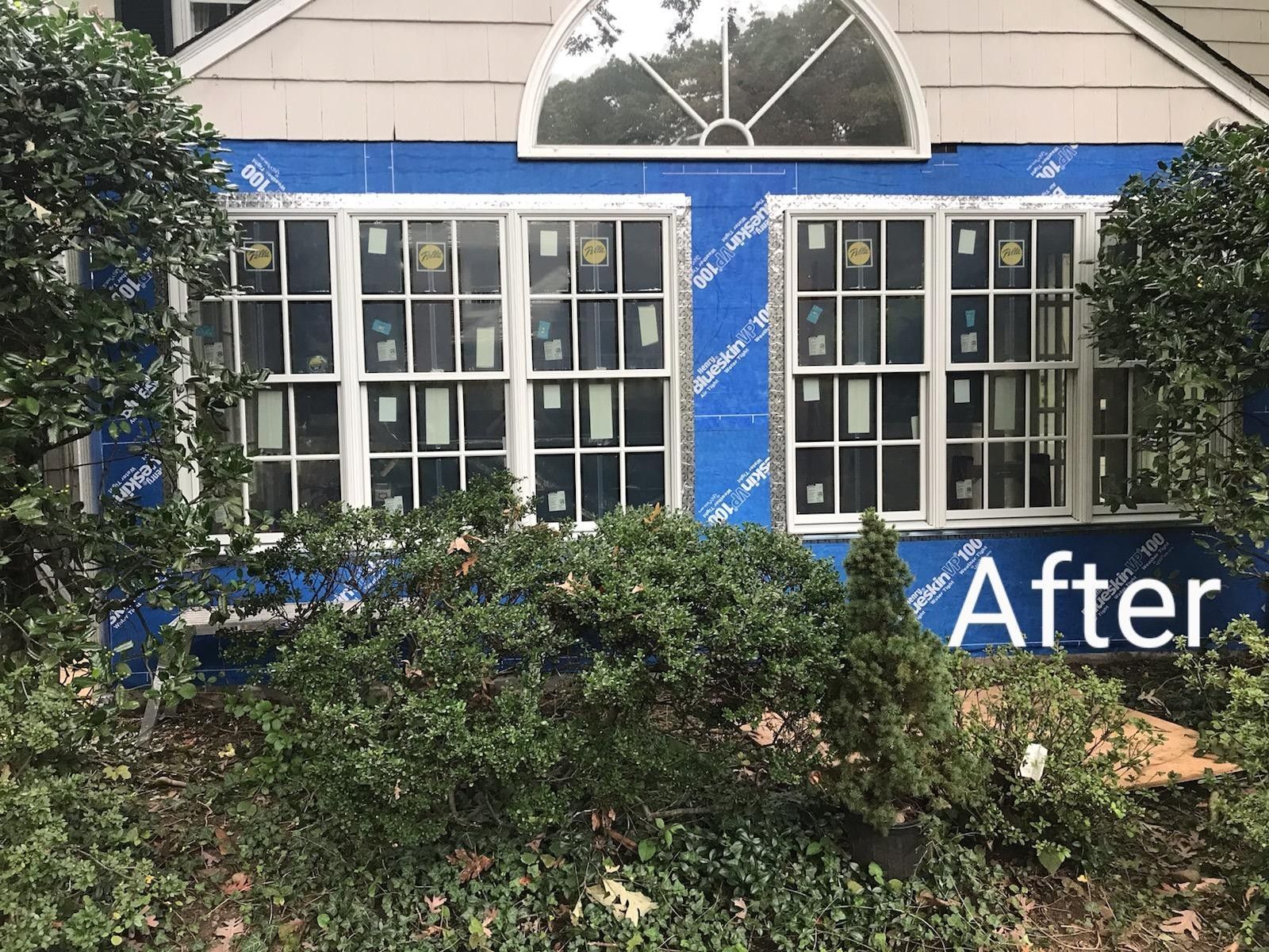 A house with a lot of windows and a sign that says after.