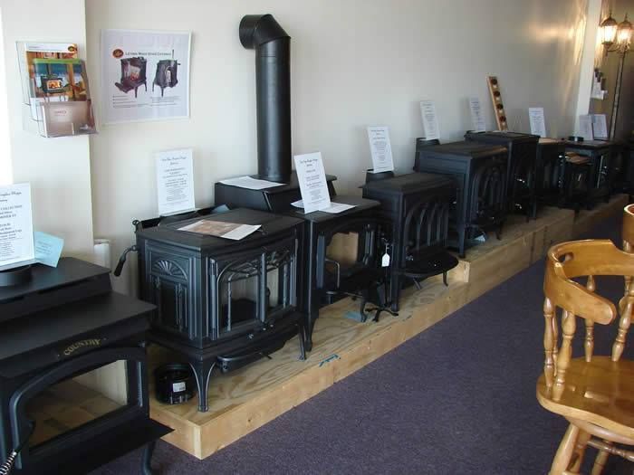 Showroom display of black cast iron stoves.