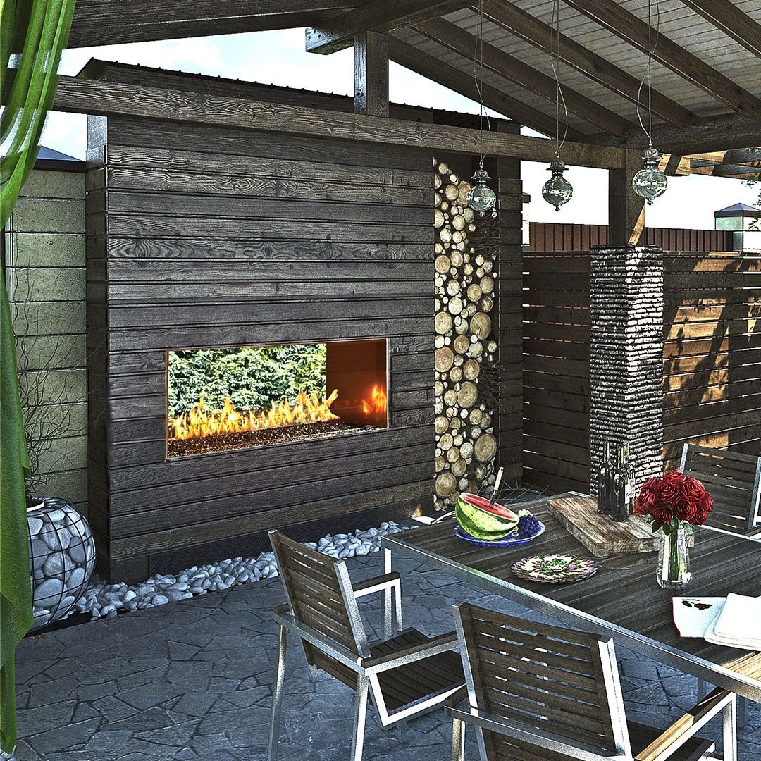 Outdoor patio with fireplace, dining table, chairs, and firewood storage.