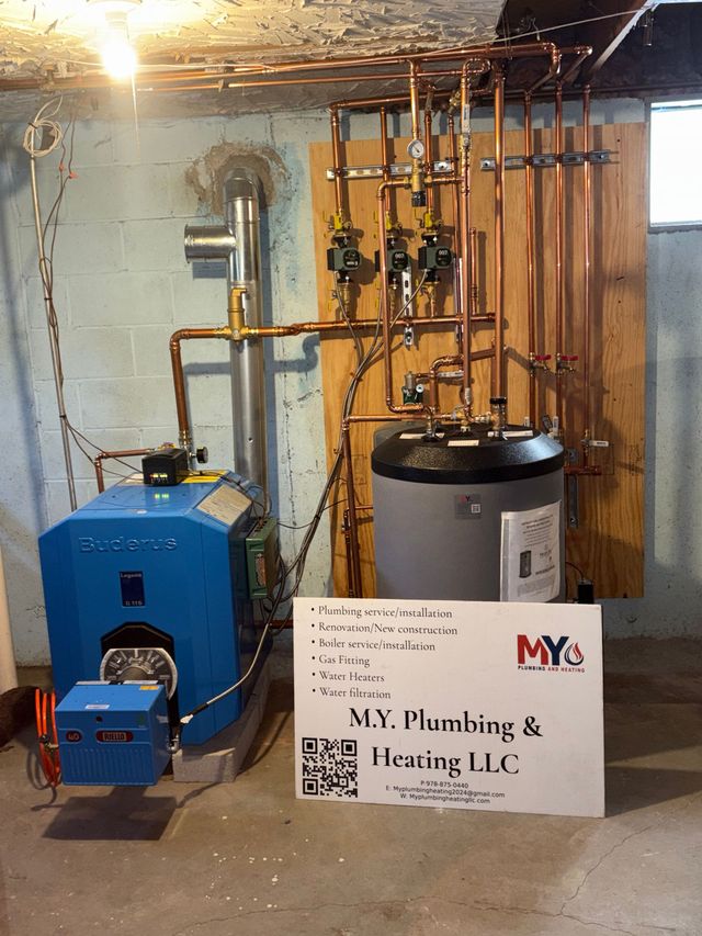 Blue furnace and water heater with copper pipes in a basement.