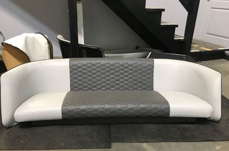 White and gray boat bench with diamond-patterned gray center. Set indoors, stairs visible in the background.