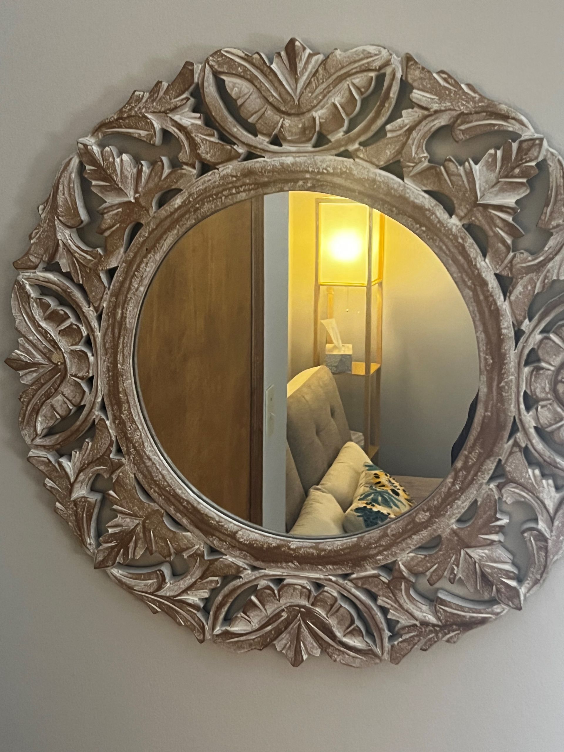 Wooden essential oil diffuser emitting vapor on a table near a gray sofa.