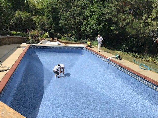 A man is working on the bottom of a swimming pool.