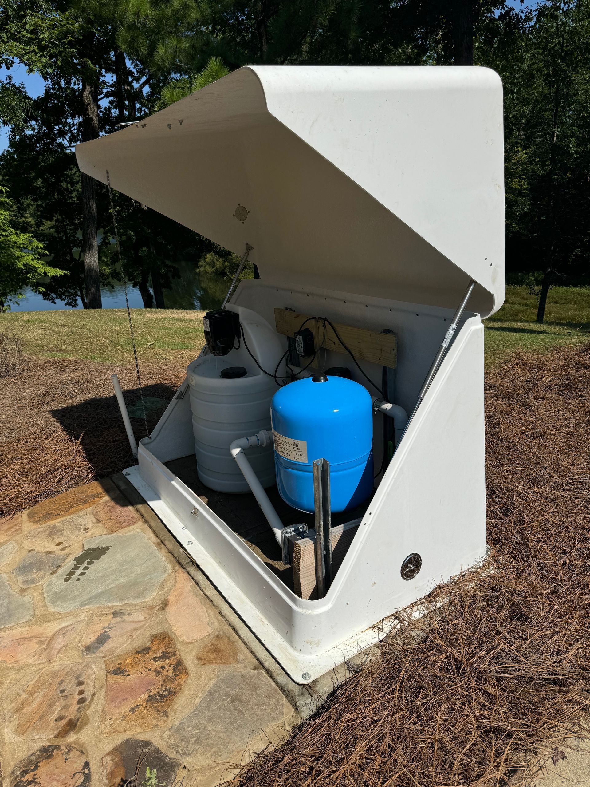 A water pump is sitting inside of a white box with the lid open.