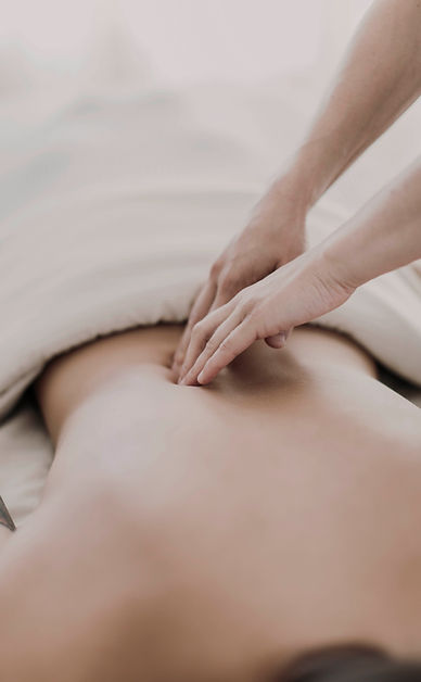 A woman is getting a massage on her back at a spa.