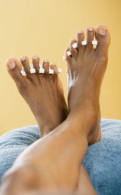 A close up of a person's feet on a blue towel.