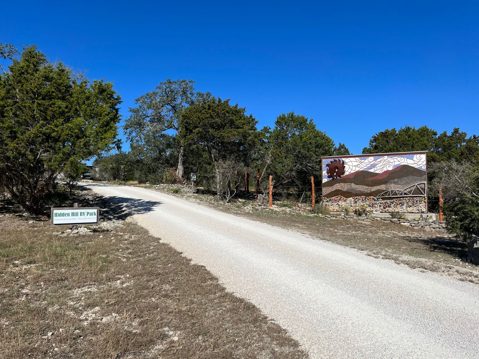 An RV park road with a sign on the side of it.
