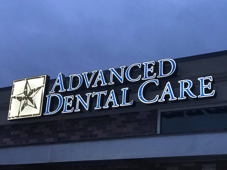 Sign for Advanced Dental Care with a star symbol on a building exterior.