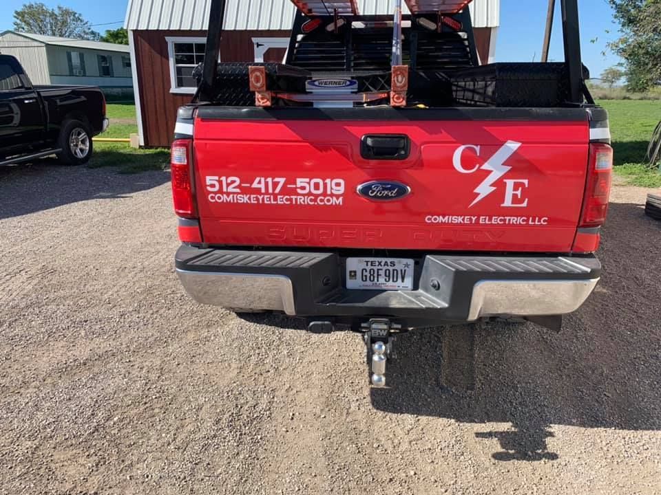 Red Ford pickup truck with the company name 