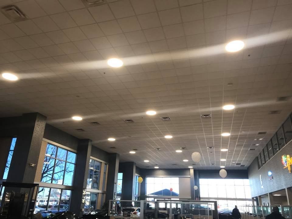 Bright interior ceiling with recessed lights, large windows, and a possible entrance.